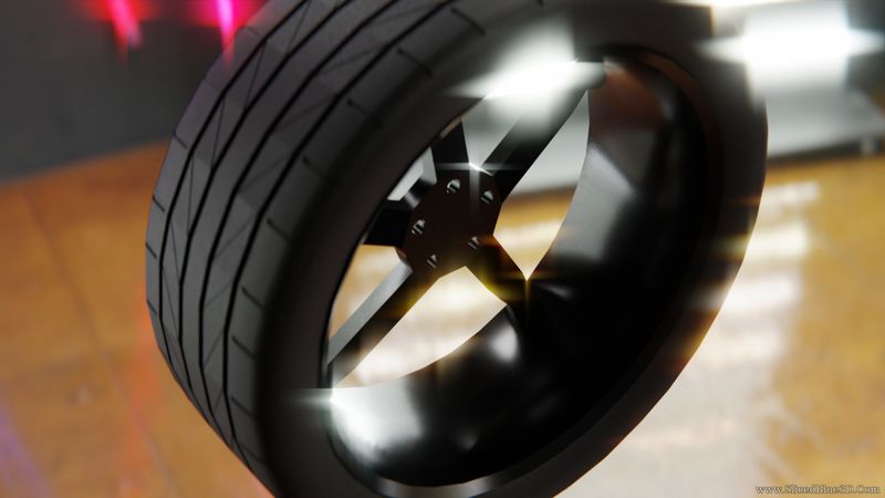 A black car wheel in a shiny room